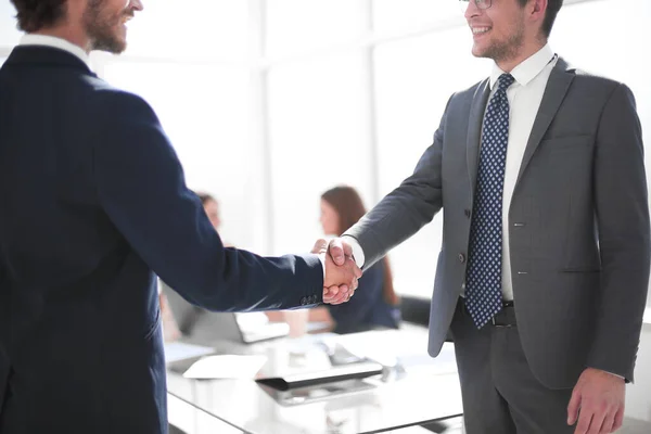 reliable handshake of business partners in the office