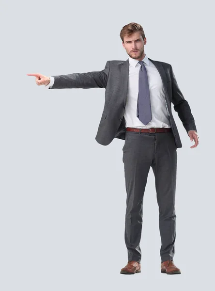 In full growth. serious businessman pointing to the side. — Stock Photo, Image