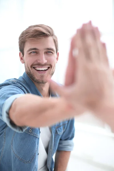 Close up. smiling young man giving high five — Stock Photo, Image