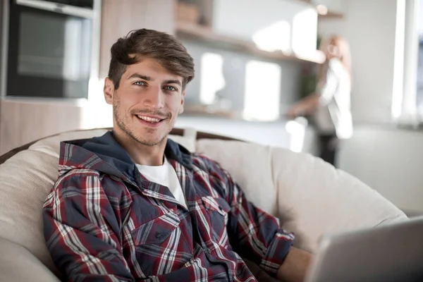 Nahaufnahme. schöner Kerl mit Laptop in der Wohnung — Stockfoto