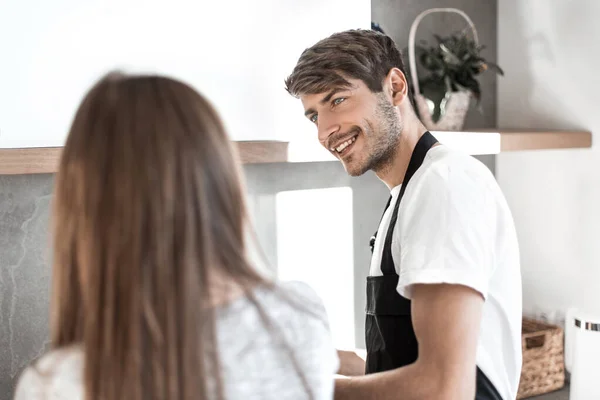 Pareja view.young trasera de pie cerca de la mesa de la cocina . —  Fotos de Stock