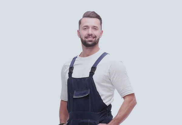 Side view. smiling man in overalls looking forward to copy space — Stock Photo, Image