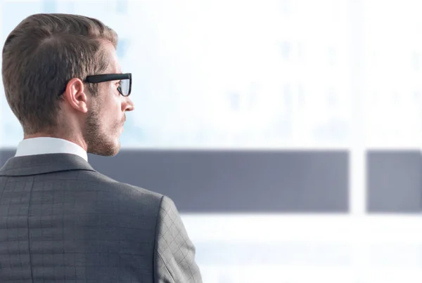 Rear view.businessman standing near the office window — Stock Photo, Image