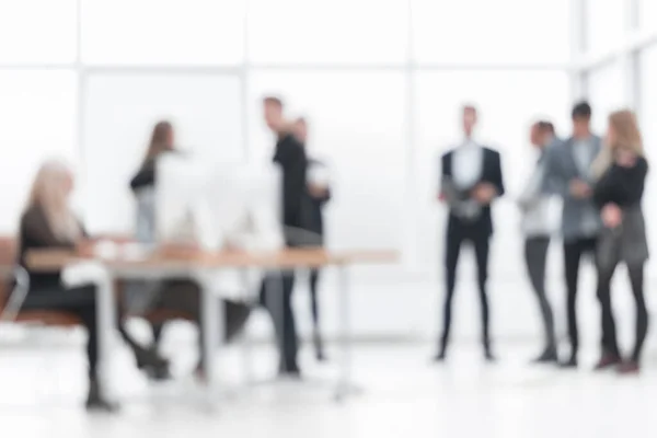 Blurry image of young business people in the office. — Stock Photo, Image