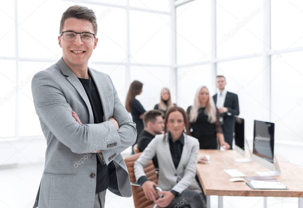 confident business man standing in the office