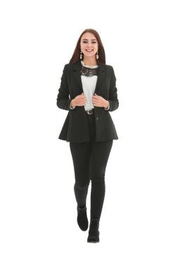 Beyaz bir arka planda tek başına yürüyen mutlu bir kadın.