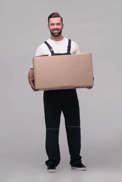 Man in workwear with cardboard box isolated on white background — Stock Photo, Image