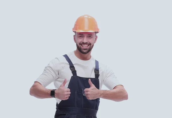 Homem sorrindo em macacão mostrando polegares para cima. isolado em branco — Fotografia de Stock