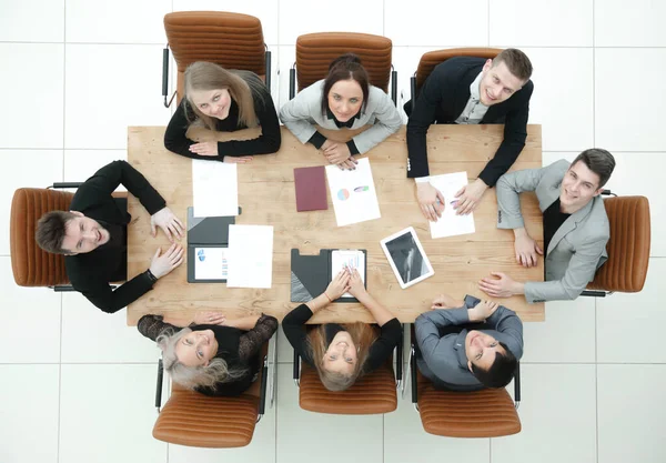 top view. young business team sitting at a table and looking at the camera