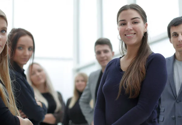 Confident young business woman standing among her colleagues — Stock Photo, Image