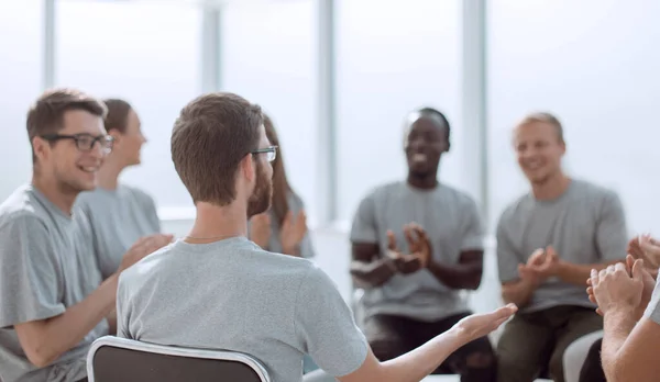 Young people are discussing something sitting in a circle. — Stock Photo, Image