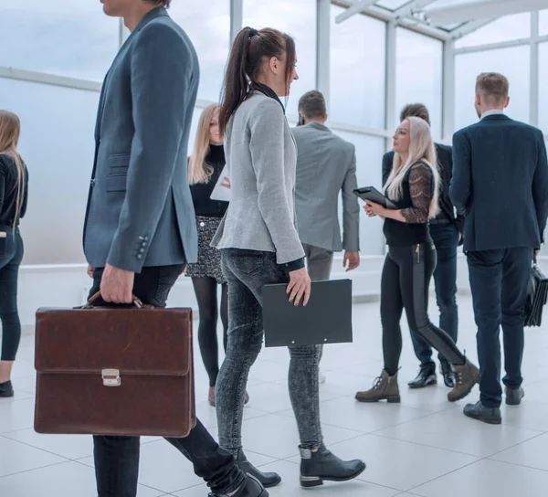 Grupp av olika affärsmän passerar i kontorslobbyn. — Stockfoto