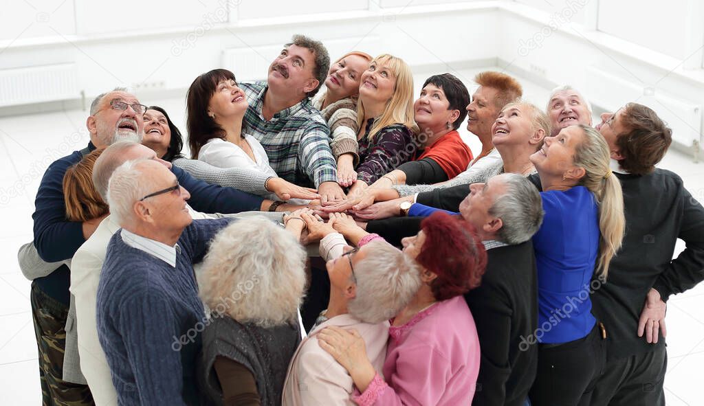 a group of people in years stand hands together