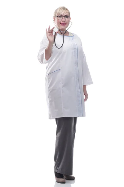 In full growth. smiling female doctor showing her stethoscope. — Stock Photo, Image