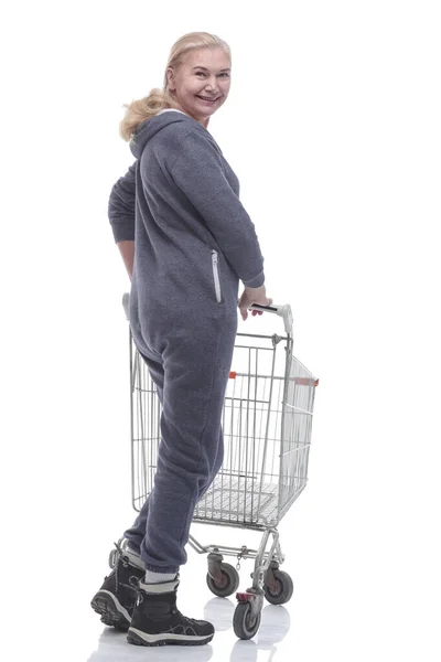 Rear view. smiling woman with shopping cart looking at you — Stock Photo, Image