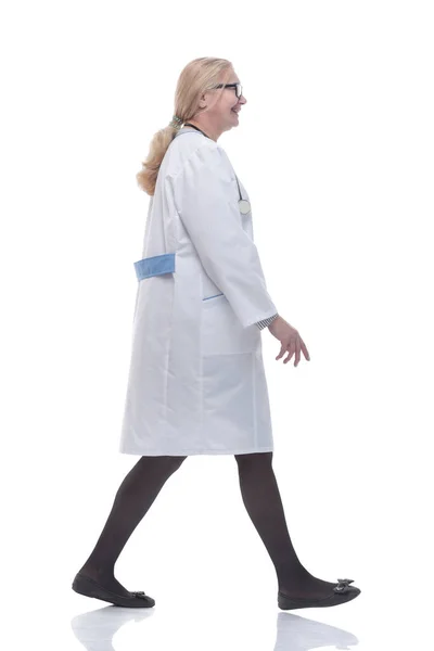 Side view. experienced female doctor stepping forward. Stock Picture