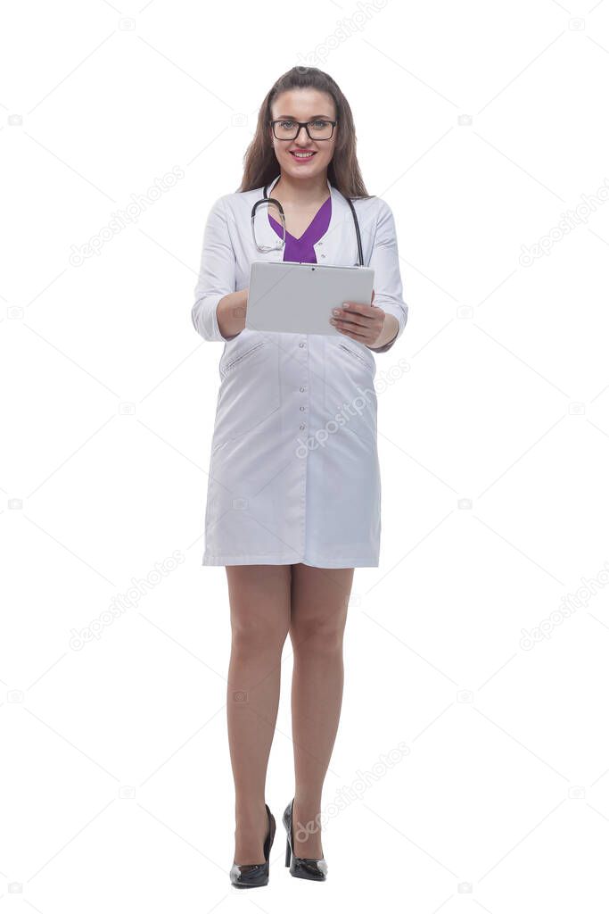 in full growth. smiling female doctor showing her stethoscope.