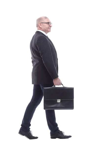 Side view. a business man with a leather briefcase striding forward — Stock Photo, Image