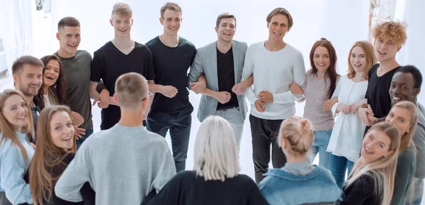 Group of different young people standing in a circle — Stock Photo, Image