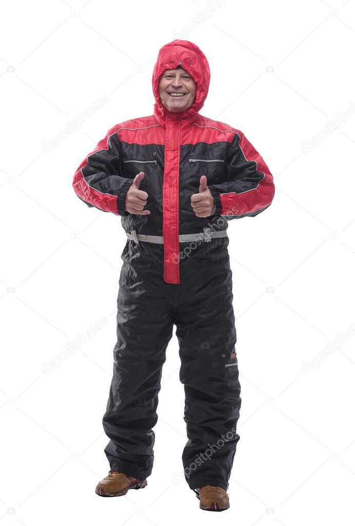 man in a winter insulated jumpsuit reading walking forward