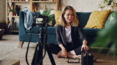 Makyöz ve blogger profesyonel kamera kullanarak yüz şekillendirme hakkında video kaydı. Genç kadın kozmetik ve fırça kit holding ve konuşma.