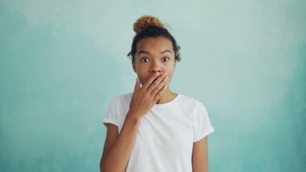 Portret van verrast Afrikaanse Amerikaanse vrouw verhogen haar wenkbrauwen en die betrekking hebben op haar mond met hand uiting van verbazing dan lachend opende. Goed nieuws en gelukkige mensen concept. — Stockvideo