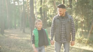 Ağır çekim Genç ailesinin sakallı adam ve sevimli oğlu hiking içinde el ele tutuşarak ve konuşurken alýþkanlýk. Baba tarafından sevgi, açık macera ve doğa kavramı.