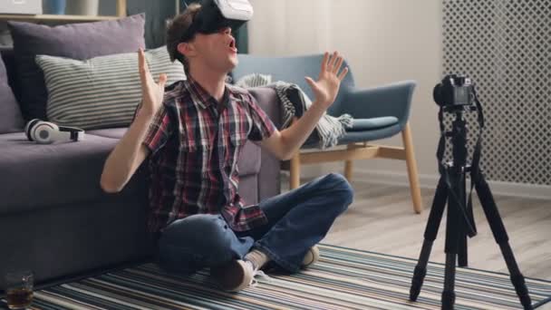 Happy young man vlogger is sharing his experience with virtual reality glasses recording video for subscribers expressing excitement and joy wearing headset. — Stock Video