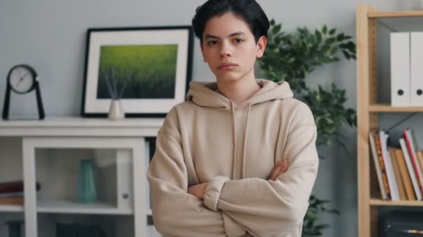 Portrait of serious teenager looking at camera with straight face at home — Stock Video