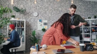Hipsters tasarımcıları düz ofis masasında yatıyordu ateş akıllı telefon kullanarak