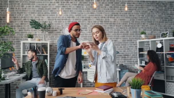 Mädchen und Mann fotografieren flache Liege auf Schreibtisch mit Smartphone-Kamera — Stockvideo