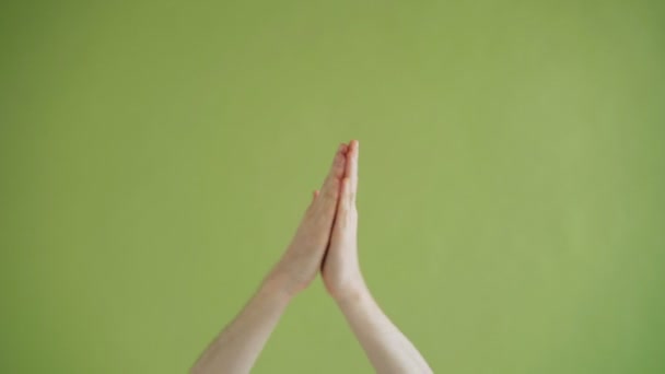 Zbliżenie strzał z rąk klaskanie pokazując kciuk-up gest na zielonym tle — Wideo stockowe