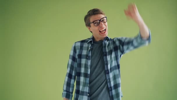 Portrait of excited young man rejoicing raising arms fists and screaming yes — Stock Video