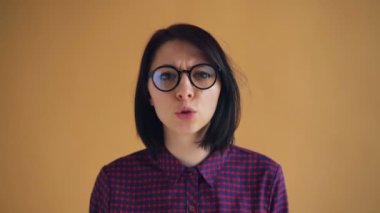 Kızgın genç kadının kollarını çırparak bağırıp salladığı yakın çekim portre