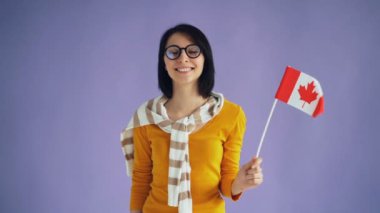 Kanada hipster ulusal bayrak kameraya bakarak gülümseyerek tutan yavaş hareket