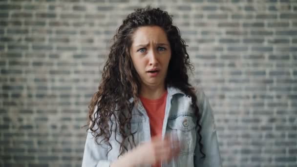 Portrait of shocked woman staring at camera with fear feeling scared moving back — Stock Video