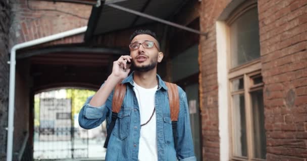 Slow motion of joyful African American guy talking on mobile phone outdoors — Stock Video