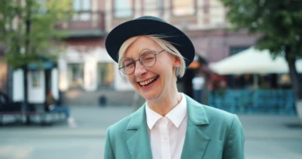 Slow motion of joyful young woman laughing outdoors in city having fun — Stock Video