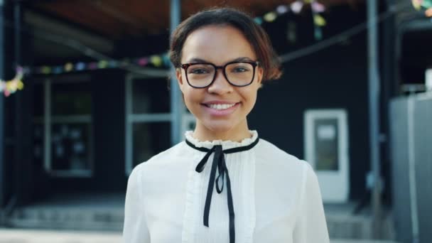 Slow motion of pretty mixed race lady showing OK hand gesture outdoors — Stock Video