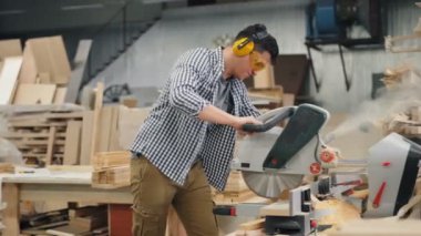 Woordworker elektrik ile çalışan meşgul atölyede ahşap testere gördüm