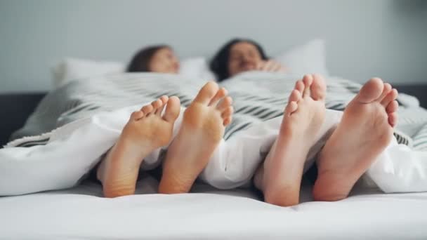 Hombres y mujeres pies moviéndose en la cama bajo manta bailando en ritmo juntos — Vídeos de Stock