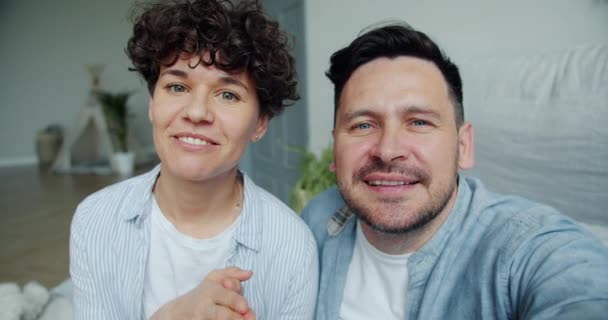 POV de hombre y mujer haciendo videollamada en línea hablando mientras el niño se mueve en la cama — Vídeos de Stock