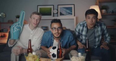 Yakışıklı adamlar tv'de yüksek beş tutan top yapıyor futbol oyunu izliyor