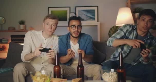 Handsome guys enjoying video game at home doing high-five having fun at night — Stock Video