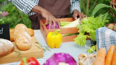 Çiftlik pazarında masaya organik sebze koyan erkek elinin yakın çekim