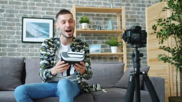 Blogger grabando video sobre gafas de realidad virtual hablando sosteniendo gadget — Vídeo de stock