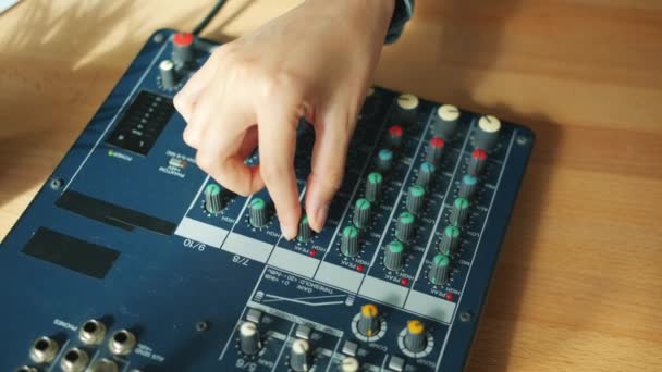 Close-up of female hand adjusting sound quality recording podcast in studio — Stock Video