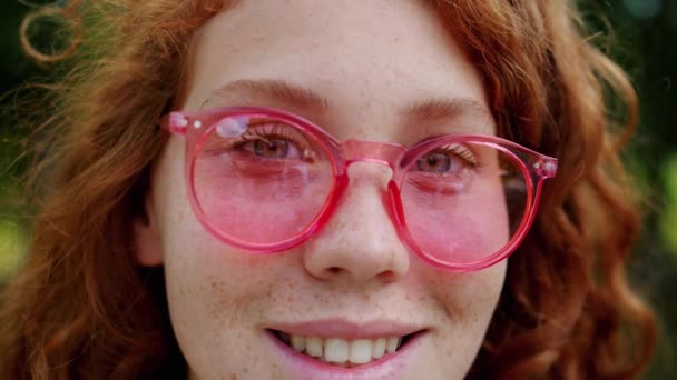 Primer plano retrato de la hermosa dama en gafas de sol sonriendo mirando a la cámara — Vídeo de stock