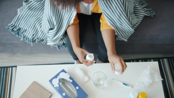 Top view of African American student taking pills during disease at home — Stok Video