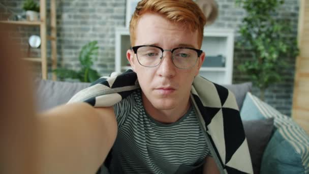 Портрет больного мужчины, показывающего таблетки, разговаривающие с врачом онлайн из дома — стоковое видео